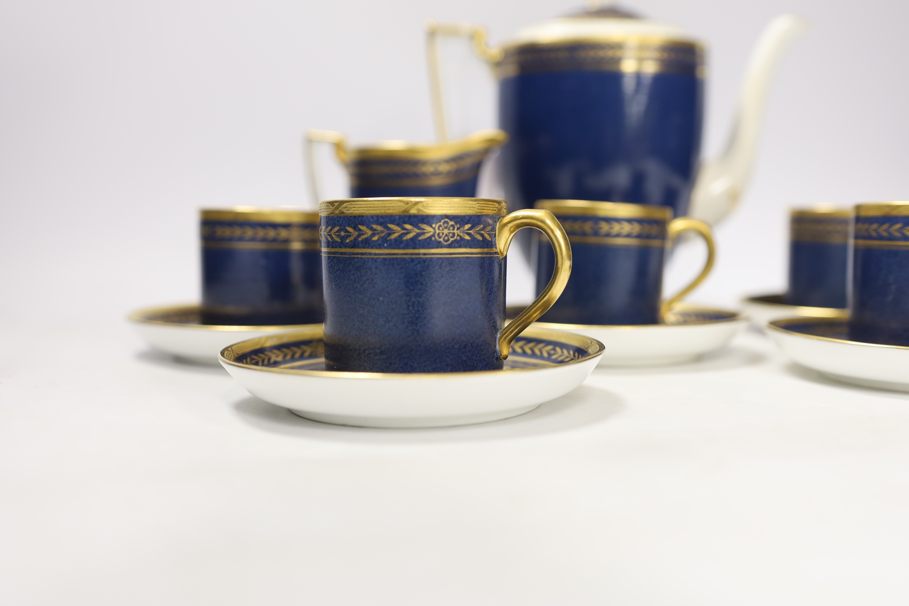 A Mintons powder blue part coffee set comprising six cans and saucers, coffee pot and milk jug together with a Staffordshire flat back figure group, 20cm wide